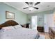 Comfortable bedroom featuring a ceiling fan, desk and ensuite bathroom at 3741 Crossing Creek Blvd, St Cloud, FL 34772