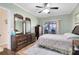 Tranquil bedroom featuring wood flooring, fan and sliding door with view to the outdoors, and a calming atmosphere at 3741 Crossing Creek Blvd, St Cloud, FL 34772