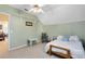 Comfortable bedroom with pitched ceiling, fan, natural light and rocking chair providing a serene and inviting space at 3741 Crossing Creek Blvd, St Cloud, FL 34772