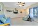 Bright living room featuring neutral walls, carpet flooring, ceiling fan and a large window at 3741 Crossing Creek Blvd, St Cloud, FL 34772