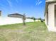 Spacious backyard enclosed with a white fence and featuring young trees at 417 Tisone Ln, Davenport, FL 33837