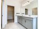 Bathroom featuring double vanity, quartz countertops, and walk-in closet at 417 Tisone Ln, Davenport, FL 33837