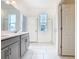 Bright bathroom with double vanity, quartz countertops, window and shower at 417 Tisone Ln, Davenport, FL 33837