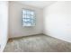 Bright bedroom featuring neutral carpet, and a window offering plenty of natural light at 417 Tisone Ln, Davenport, FL 33837