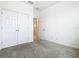 Bedroom with carpeted floor, open doorway and double closets at 417 Tisone Ln, Davenport, FL 33837