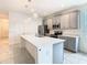 Bright kitchen featuring gray cabinets, pendant lighting, stainless appliances, and a large island at 417 Tisone Ln, Davenport, FL 33837