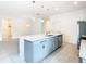 Stylish kitchen island with stainless steel dishwasher, pendant lighting, and an eat-in bar at 417 Tisone Ln, Davenport, FL 33837