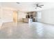 Open-concept living room with stainless appliances, gray cabinetry, and bright tile flooring at 417 Tisone Ln, Davenport, FL 33837