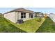 Expansive backyard area with healthy green grass and rear home exterior at 444 Lily Ln, Davenport, FL 33837