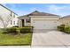 Charming single-story home with a two-car garage and well-maintained landscaping at 444 Lily Ln, Davenport, FL 33837