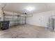 Spacious two-car garage with concrete floor, automatic door, and door to the house at 444 Lily Ln, Davenport, FL 33837