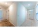 Hallway featuring tile floors near the entrance and carpet leading to other rooms in the house at 444 Lily Ln, Davenport, FL 33837