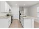 Modern kitchen featuring white cabinetry, a center island, and stainless steel appliances at 444 Lily Ln, Davenport, FL 33837