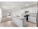 Bright kitchen with a center island, modern appliances, and plenty of counter space at 444 Lily Ln, Davenport, FL 33837