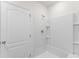 Modern shower with a built in shelf and bright white door at 444 Lily Ln, Davenport, FL 33837