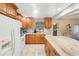 Well-lit kitchen with wood cabinets, stone countertops, and tile flooring at 4500 Lake Trudy Dr, St Cloud, FL 34769