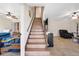 Inviting staircase connecting the home's levels, complemented by stylish decor and tiled floors at 4500 Lake Trudy Dr, St Cloud, FL 34769