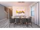 Bright dining room features a glass table with seating for ten and a modern light fixture at 4807 Kings Castle Cir, Kissimmee, FL 34746