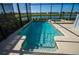 Screened-in pool with a built-in spa and relaxing views of the adjacent lake at 4807 Kings Castle Cir, Kissimmee, FL 34746