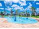 Community splash pad with water jets and colorful features for Gathering fun in a sunny environment at 4807 Kings Castle Cir, Kissimmee, FL 34746