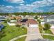 A high angle, slightly elevated view of a single story home with solar panels on the roof at 5113 Sage Way, Kissimmee, FL 34758