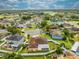 Aerial view of a residential neighborhood, single-story home with solar panels and green surroundings at 5113 Sage Way, Kissimmee, FL 34758