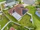 Bird's-eye view of the home and backyard showcasing the enclosed patio and solar panel installation at 5113 Sage Way, Kissimmee, FL 34758