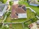 Bird's eye view of a fenced backyard with screened in patio and solar panels on a single-story home at 5113 Sage Way, Kissimmee, FL 34758