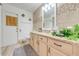 Bathroom with a granite-topped vanity and decorative wall mirror at 5113 Sage Way, Kissimmee, FL 34758