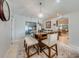 Cozy dining area with modern chandelier, seating for four, and open access to living area at 5113 Sage Way, Kissimmee, FL 34758