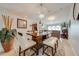 Charming dining area with modern chandelier, seating for four, and view of the living space at 5113 Sage Way, Kissimmee, FL 34758