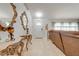 Inviting foyer with elegant console tables, decorative mirrors and a view of the front door at 5113 Sage Way, Kissimmee, FL 34758