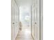 Hallway with white closet doors on each side and bathroom in the distance at 5113 Sage Way, Kissimmee, FL 34758