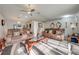 Comfortable living room featuring a ceiling fan, accent furniture, and ample natural light at 5113 Sage Way, Kissimmee, FL 34758