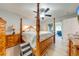 Airy main bedroom with four-poster bed and decorative wood, flowing into a bright sunroom at 5113 Sage Way, Kissimmee, FL 34758