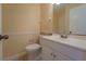 Cozy bathroom with a white vanity, toilet, and decorative mirror at 5445 Marvell Ave, Orlando, FL 32839