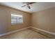 Bright bedroom with tile flooring, a ceiling fan, and a window providing natural light at 5445 Marvell Ave, Orlando, FL 32839