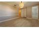 Bright bedroom featuring neutral walls, tile flooring, and a stylish modern light fixture at 5445 Marvell Ave, Orlando, FL 32839