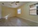 Bright and airy bedroom with tile floors, ceiling fan, closet, and natural light at 5445 Marvell Ave, Orlando, FL 32839