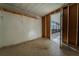 Unfinished empty room with concrete floors, wood studs, and shelving; ready for customization at 5445 Marvell Ave, Orlando, FL 32839