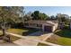 Aerial view of a cozy home with mature trees, fenced backyard, and driveway at 5445 Marvell Ave, Orlando, FL 32839