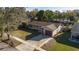 Aerial view of a single-story home with a garage, driveway, and well-maintained lawn at 5445 Marvell Ave, Orlando, FL 32839