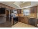 Functional kitchen featuring sleek black appliances, granite countertops, and ample cabinet space at 5445 Marvell Ave, Orlando, FL 32839