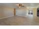 Spacious living room featuring tile floors, ceiling fan, and sliding glass doors to the lanai at 5445 Marvell Ave, Orlando, FL 32839