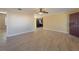 Open-concept living room with tile floors leading into a modern kitchen and entryway at 5445 Marvell Ave, Orlando, FL 32839