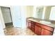 Bathroom featuring double sinks with granite countertop and vanity storage at 553 Viceroy Ct, Kissimmee, FL 34758