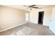 Neutral bedroom featuring plush carpeting, ceiling fan, and a window for natural light at 553 Viceroy Ct, Kissimmee, FL 34758