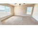 Bedroom with neutral walls, carpeting, and two windows offering ample natural light at 553 Viceroy Ct, Kissimmee, FL 34758