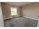 Bright bedroom featuring neutral walls, plush carpeting, and a window with natural light at 553 Viceroy Ct, Kissimmee, FL 34758