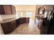 Spacious kitchen featuring dark wood cabinets, stainless steel sink, and modern appliances at 553 Viceroy Ct, Kissimmee, FL 34758